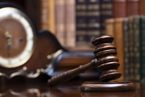 An image of a lawyer's office zoomed in on a gavel on the table